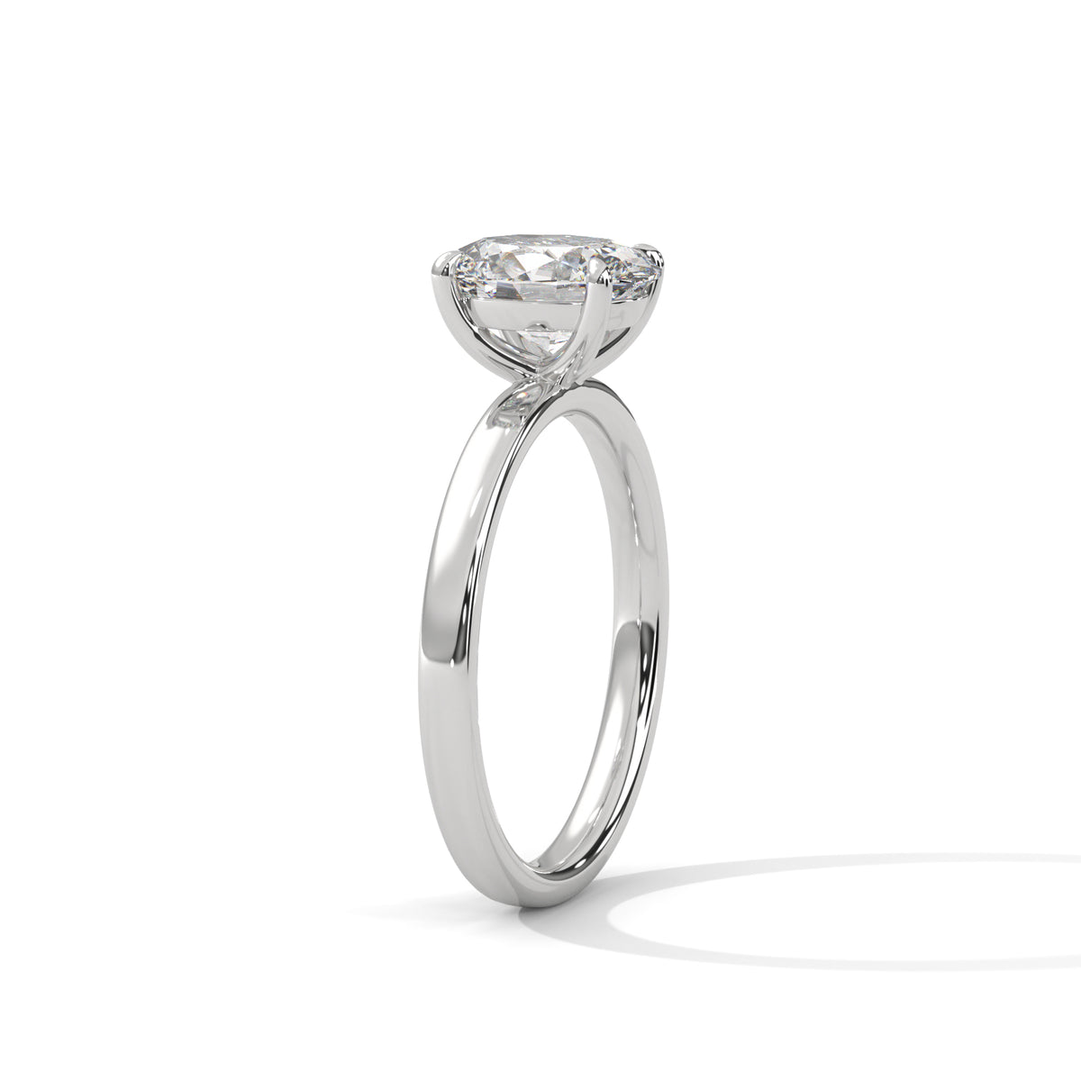 A classic solitaire engagement ring featuring a round brilliant-cut diamond set in a polished white gold or platinum band, shown on a clean white background with a soft shadow.