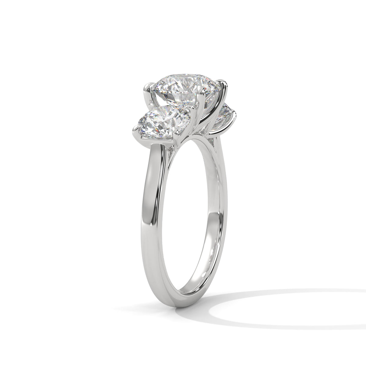 Diamond ring with a pear-shaped center stone on a white background