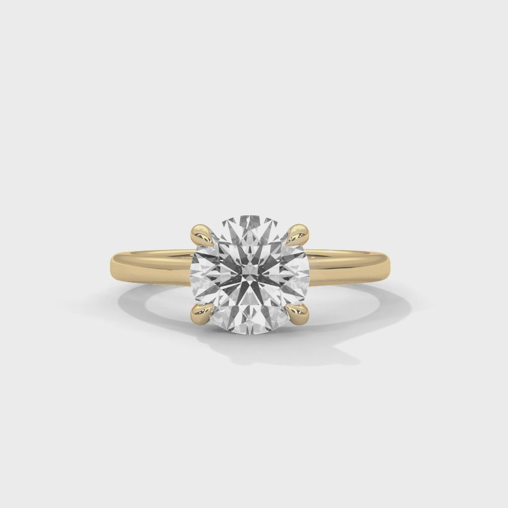 Anillo de compromiso solitario de diamante redondo con cuatro garras entrelazadas y brazo tipo catedral