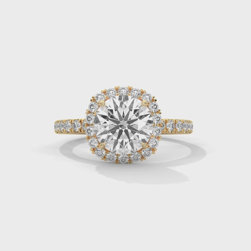 Anillo de diamantes de talla brillante redonda y perfil alto, con halo de cojín suave y brazo con pavé