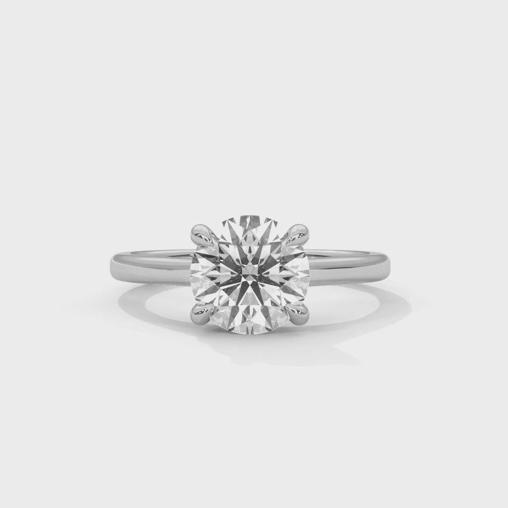 Anillo de compromiso solitario de diamante redondo con cuatro garras entrelazadas y brazo tipo catedral