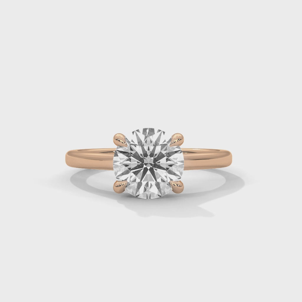 Anillo de compromiso solitario de diamante redondo con cuatro garras entrelazadas y brazo tipo catedral